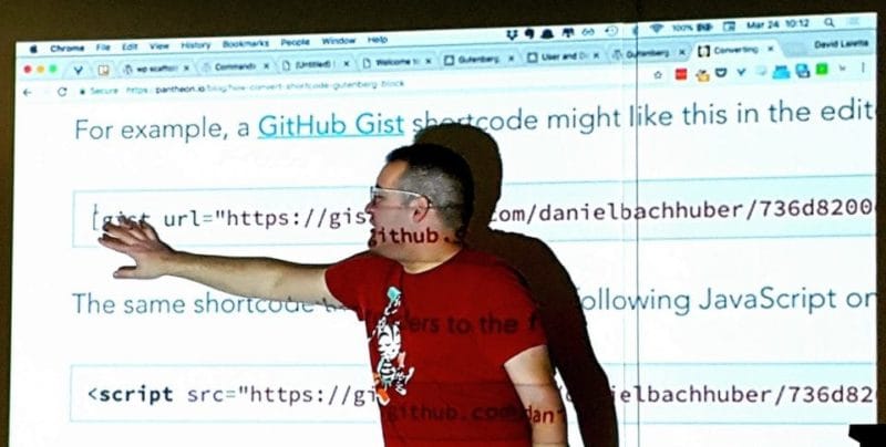 david Wolfpaw standing in front of code from a projector