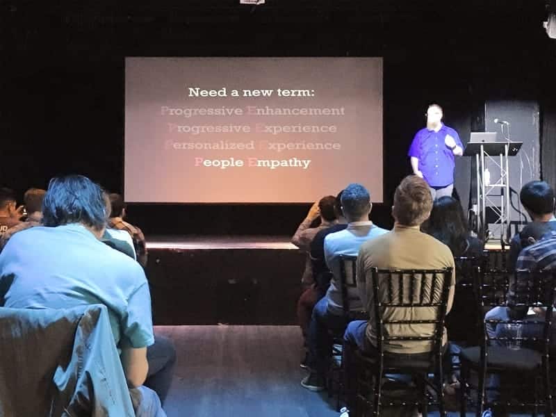 Kyle Simpson at Flashback Conference 2020 in Orlando. Slide reads, "Need a new term: Progressive Enhancement, Progressive Experience, Personalized Experience, People Empathy", with all options dimmed except for People Empathy