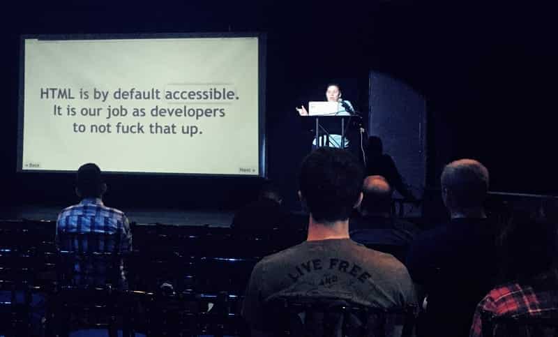 Estelle Weyl at Flashback Conference 2020 in Orlando. Slide text reads, "HTML is by default accessible. It is our job as developers not to fuck that up."