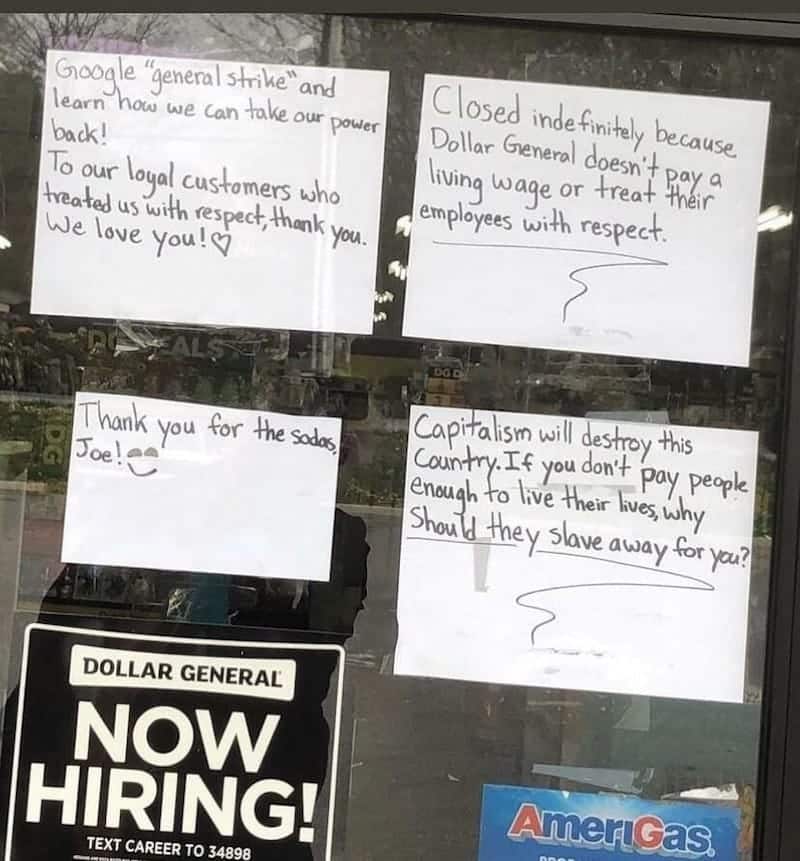 screenshot of a picture of signs on a Dollar General describing the reason that all of the employees are striking